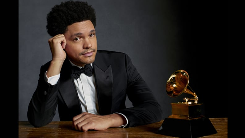 An image of Trevor Noah in a suit alongside a Grammy award.